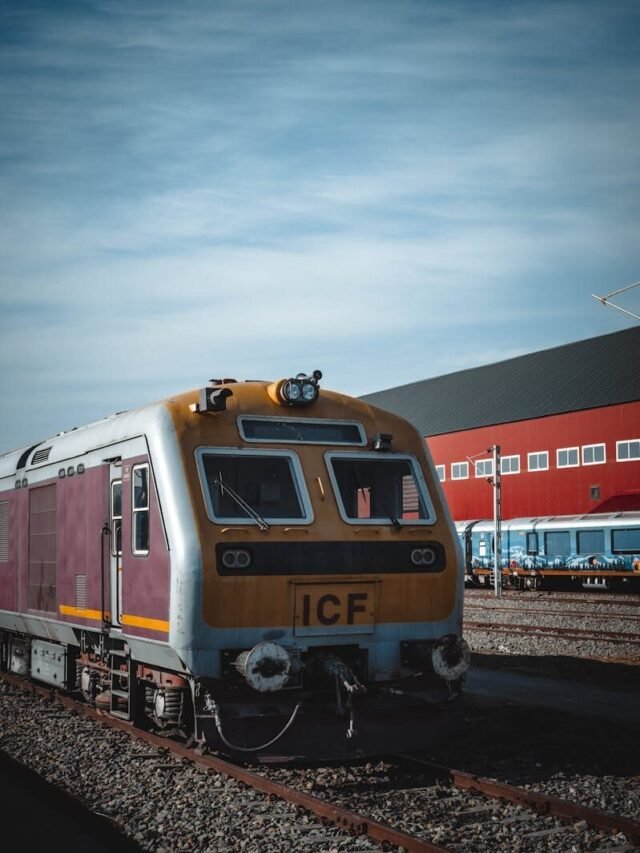 Front view of a modern train on railway tracks at Mirgund station under a clear blue sky.