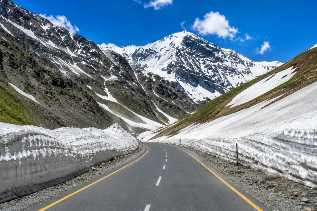 Zojila Pass open in summer on the Srinagar to Kargil route with clear road and snow walls